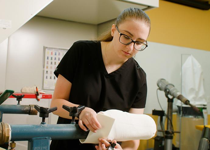 Julie Czech works on a prosthesis in a lab