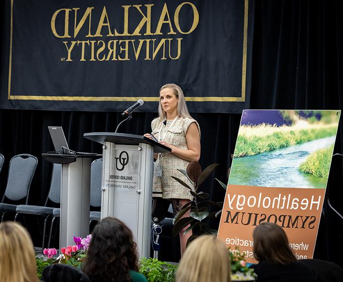 A person standing at a podium giving a speech