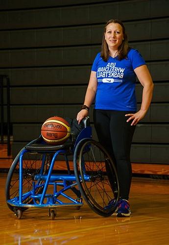 Women with basketball on wheelchair