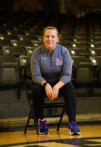 Woman sitting in chair on basketball court