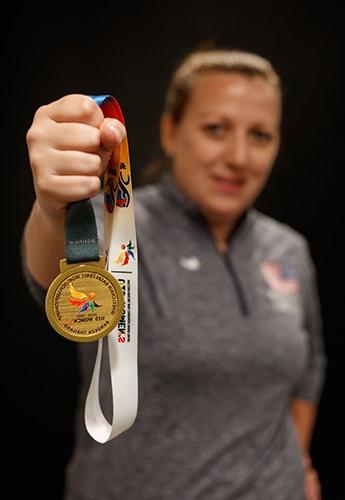 Woman holding paralympic medal